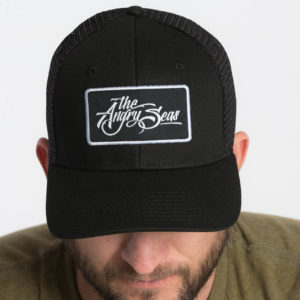 Product: "Signature Script" Snapback Hat // Description: Semi-Curved Bill mesh snapback hat with woven label appliqué // Color: Black on Black // Brand: The Angry Seas Clothing