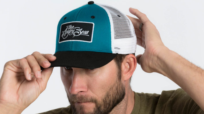 Product: "Ture Script" Snapback Hat // Description:  Semi-Curved Bill mesh snapback hat with woven label appliqué // Color: Teal on White // Brand: The Angry Seas Clothing