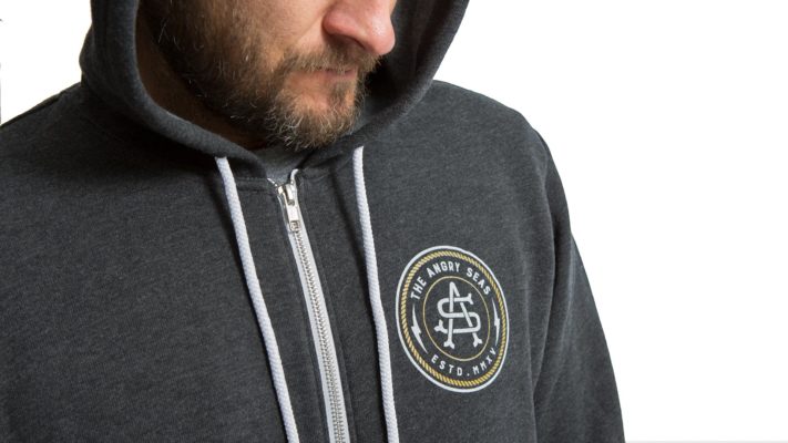 Product: "Captains Monogram Design" // Description: Front Zip Hooded Sweatshirt with Angry Seas Captain's Monogram screen printed graphic // Color: Charcoal // Brand: The Angry Seas Clothing